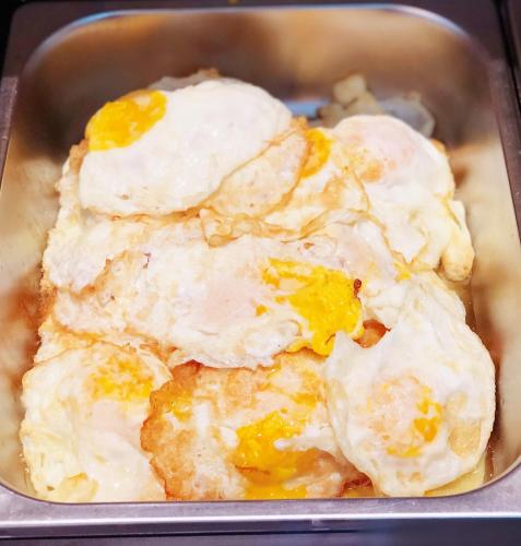 a muffin tin with two fried eggs in it at Shenzhen Kaili Hotel, Guomao Shopping Mall in Shenzhen
