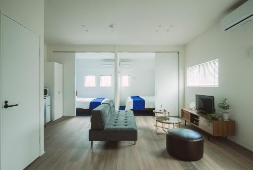a living room with a couch and a bedroom at Seacruise House Navio in Kami Amakusa