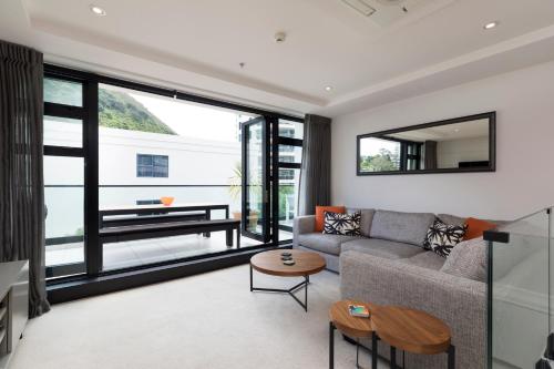 a living room with a couch and a table at Ocean Eleven 5 in Mount Maunganui