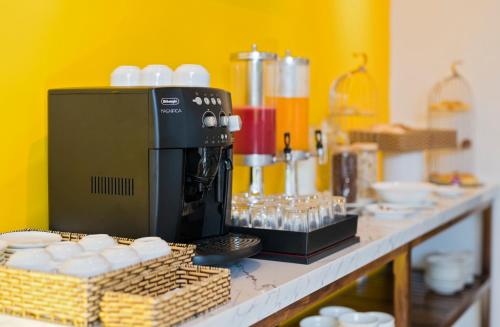 a counter with a coffee maker on top at December Hoi An Villa in Hoi An