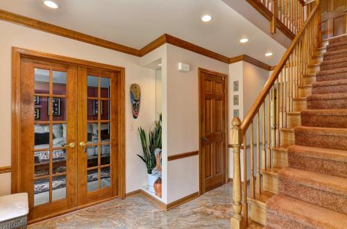 a staircase in a home with wooden railings and wooden doors at Arborhouse **** Naperville-Lisle in Lisle