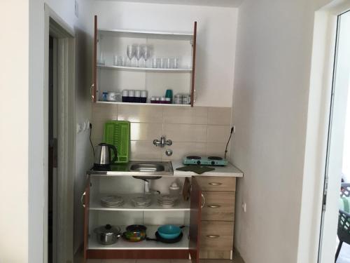 a small kitchen with a sink in a room at DK Apartmani in Dobra Voda