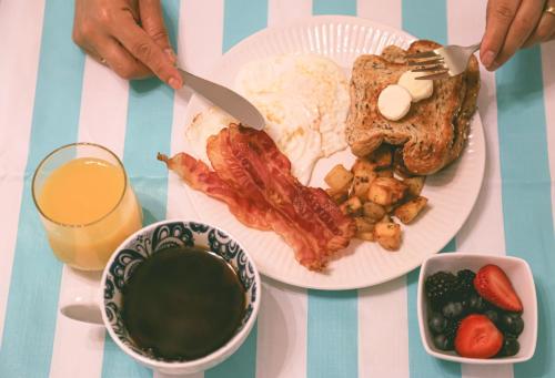 a plate of breakfast food with bacon eggs and toast at Inn on Canyon in Radium Hot Springs