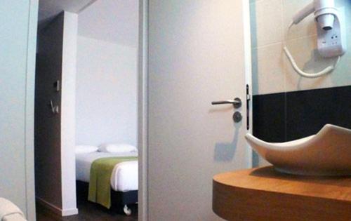 Postel nebo postele na pokoji v ubytování Hôtel de la Louée