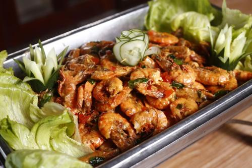 a tray of food with chicken and lettuce on a table at Sutera at Mantanani Island Resort & Spa in Mantanani Island 