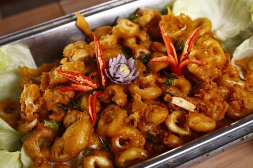 a dish of food with shrimp in a tray at Sutera at Mantanani Island Resort & Spa in Mantanani Island 