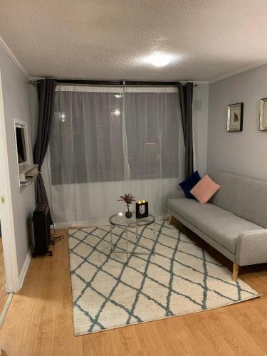 a living room with a couch and a table at Stay Santiago Lastarria Bellas Artes in Santiago