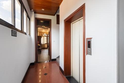 a hallway with white walls and wooden ceilings at Hanoi Little Town Hotel in Hanoi