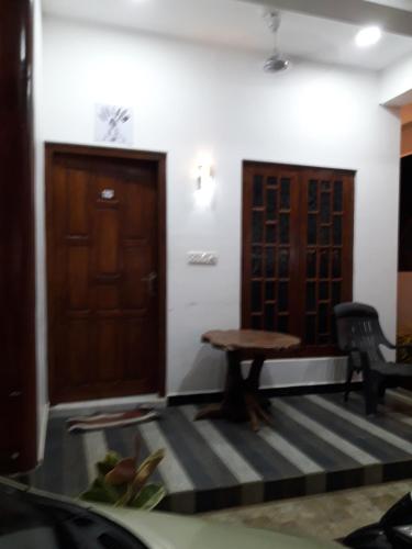 a room with a table and a wooden door at Surf reef beach in Trincomalee
