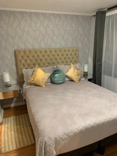 a bedroom with a large bed with gold pillows at Stay Santiago Lastarria Bellas Artes in Santiago
