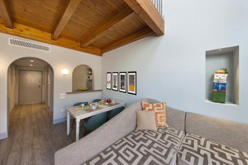 a living room with a couch and a table at Amore Rentals - Casa La Maisonette in Sorrento
