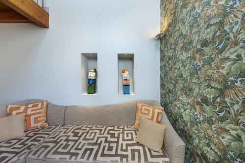 a living room with a couch and a wall at Amore Rentals - Casa La Maisonette in Sorrento