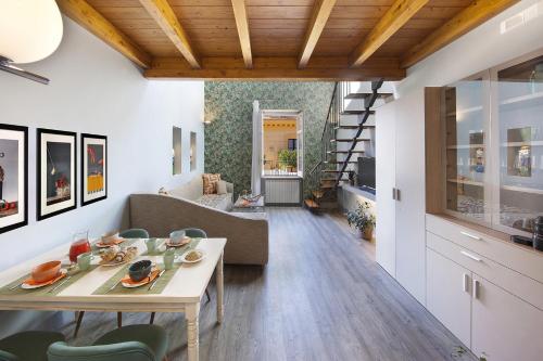 a living room with a table and a couch at Amore Rentals - Casa La Maisonette in Sorrento