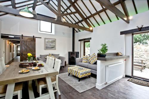 a living room with a table and a couch at The Barn in Lanhydrock, Bodmin in Bodmin
