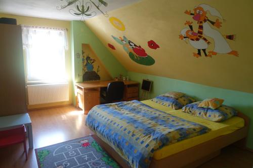 1 dormitorio con cama, escritorio y ventana en ČAKOVÁ 116, en Čaková