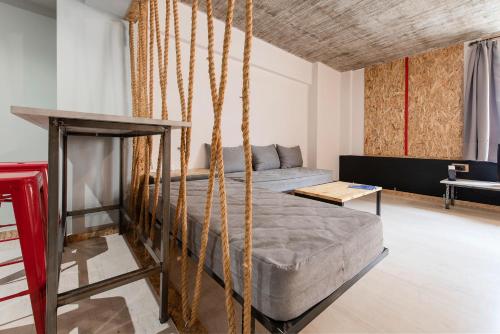 una habitación con una cama con cuerdas alrededor en Piraeus Premium Suites, en Pireo