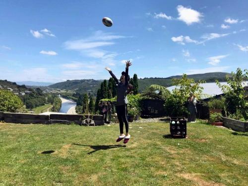 a woman jumping in the air to catch a frisbee at rooms with a view in Haywards