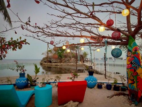 a group of blue vases sitting on the beach at Bolo Beach Santorini nearby to Hundred Island in Alaminos