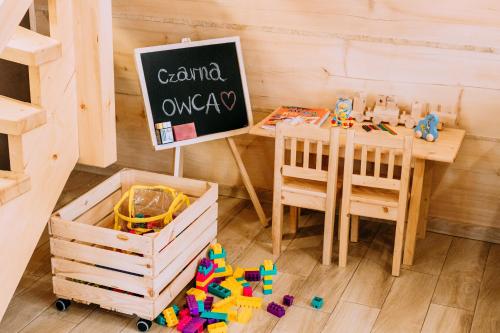 a childs desk with a table and a chalkboard at Czarna Owca in Kościelisko