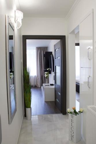 a hallway with a door and a mirror in a room at Luxury Dream Apartman in Eger