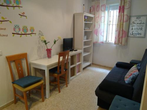 a living room with a table and chairs and a couch at Cádiz Apartamento Mentidero Plaza in Cádiz