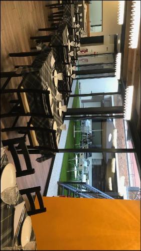 a row of tables and chairs in a building at Wood Steel & Glass in Marinha Grande