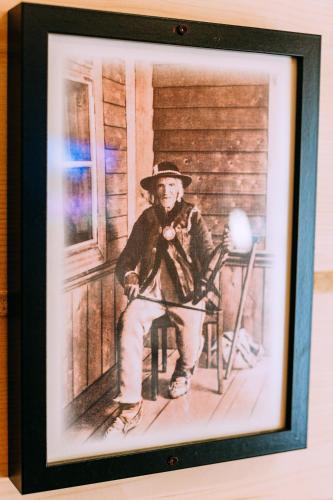 an old picture of a man sitting on a porch at Czarna Owca in Kościelisko