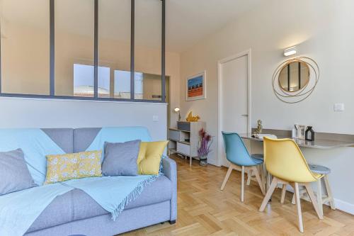 un salon avec un canapé bleu et des chaises dans l'établissement Maison Bianchi - 45 Berlioz, à Nice