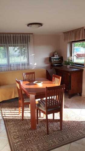 a wooden table and chairs in a living room at Kuća za odmor JAPICA in Sveti Martin na Muri