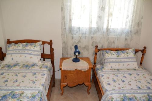 a bedroom with two beds and a lamp on a table at Traditional summer house in Marmari in Marmarion