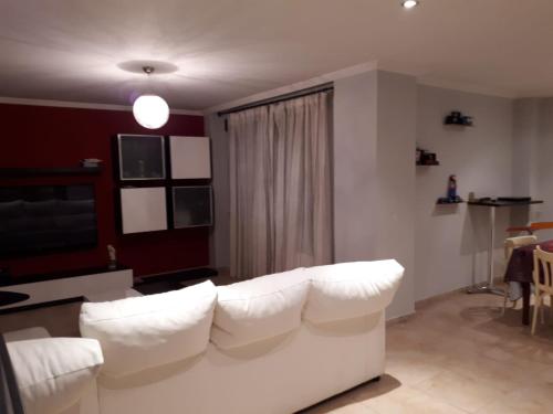 a living room with a white couch and a table at Villa Miranda in Carrascal de Barregas