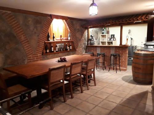 a dining room with a wooden table and chairs at Villa Miranda in Carrascal de Barregas
