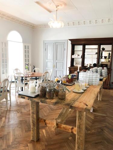 a large wooden table with dishes on it in a room at Sjöbo Gästgifvaregård in Sjöbo