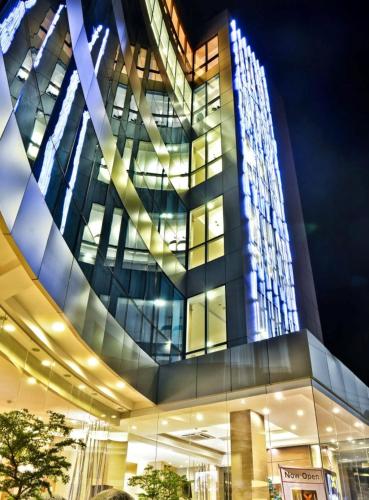 a large building with lights on it at night at D'Hotel & Suites in Dipolog