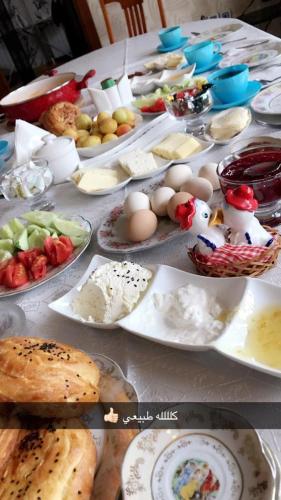 a table with many plates of food on it at House in Quba in Quba