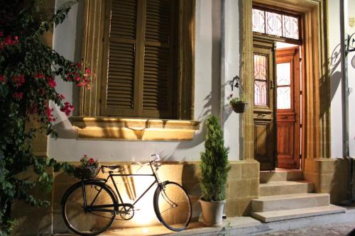 a bike parked in front of a house with a door at Pedieos Guest House in Lefkosa Turk