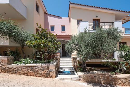 a villa with a staircase in front of a house at Cyrenia Guesthouse in Monemvasia