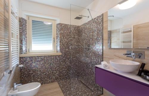 a bathroom with a tub and a sink and a shower at Domus Bellagio in Bellagio
