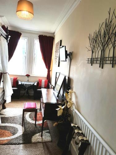 a living room with a couch and a table at The Palms Guest house in Torquay