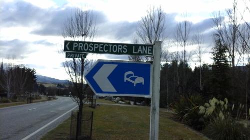 a street sign on the side of a road at Cardrona Ski Apartment in Wanaka