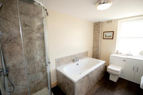 a bathroom with a shower and a sink and a toilet at The Morritt Hotel in Barnard Castle