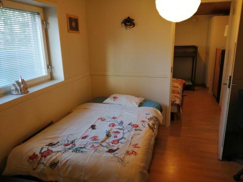 a small bedroom with a bed in a room with a window at Cozy Cityhome Pirkankatu in Tampere