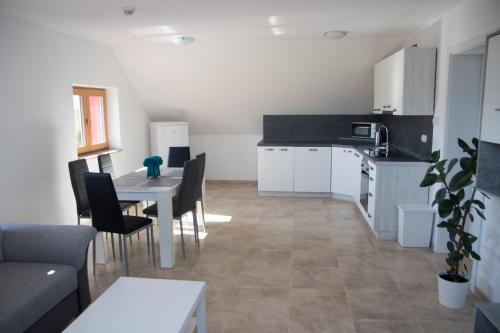 a kitchen and dining room with a table and chairs at Apartmán U Fuxů in Žleby