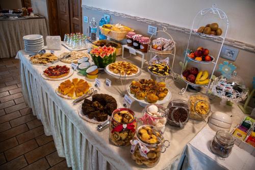 a table with many plates of food on it at Agriturismo B&B Vista Parco in Savio di Ravenna