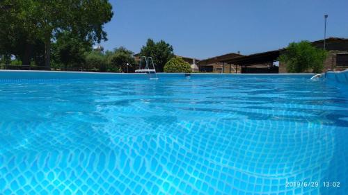 a large swimming pool with blue water at Agricampolungo Monterosi in Monterosi