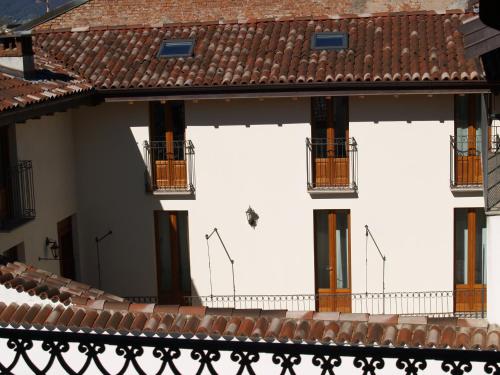 a building with white walls and orange balconies at Casa Botta - Luino Lago Maggiore in Luino