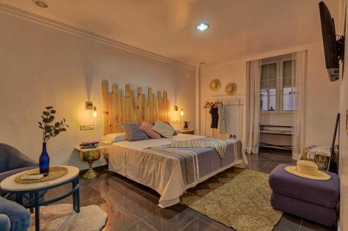 a bedroom with a bed and a living room at ROOMQUEO-Only Adults in Barbate