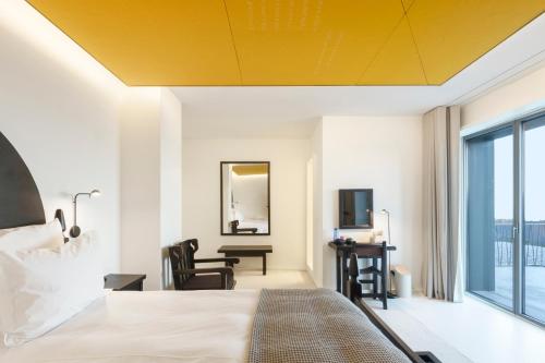 a hotel room with a yellow ceiling at Casa de São Lourenço - Burel Panorama Hotel - member of Design Hotels in Manteigas