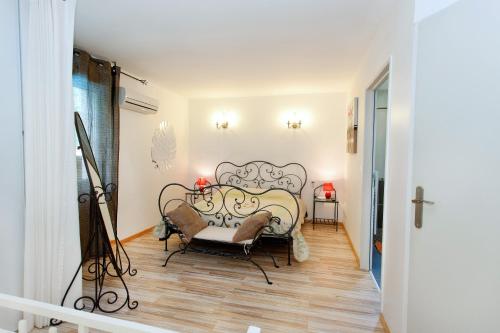 a bedroom with a bed and a chair in a room at Le Domaine de Charline de 1 à 35 personnes in Issel