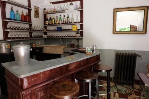 a bar with stools and a counter with bottles at Justin de Provence in Orange
